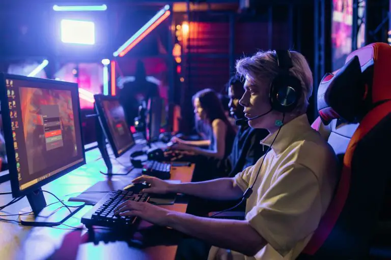 person wearing headset at gaming computer desk